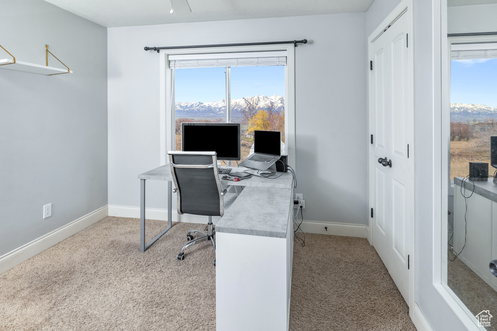 Office area featuring plenty of natural light, light colored carpet, and ceiling fan