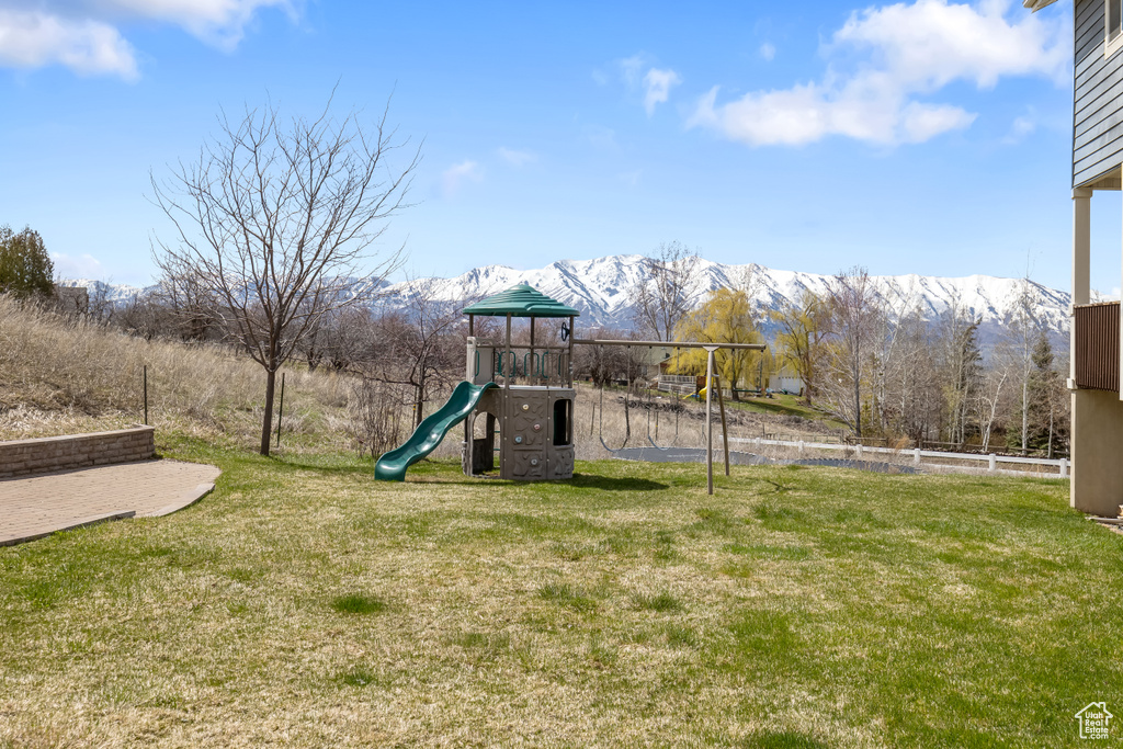 View of play area featuring a lawn and a mountain view
