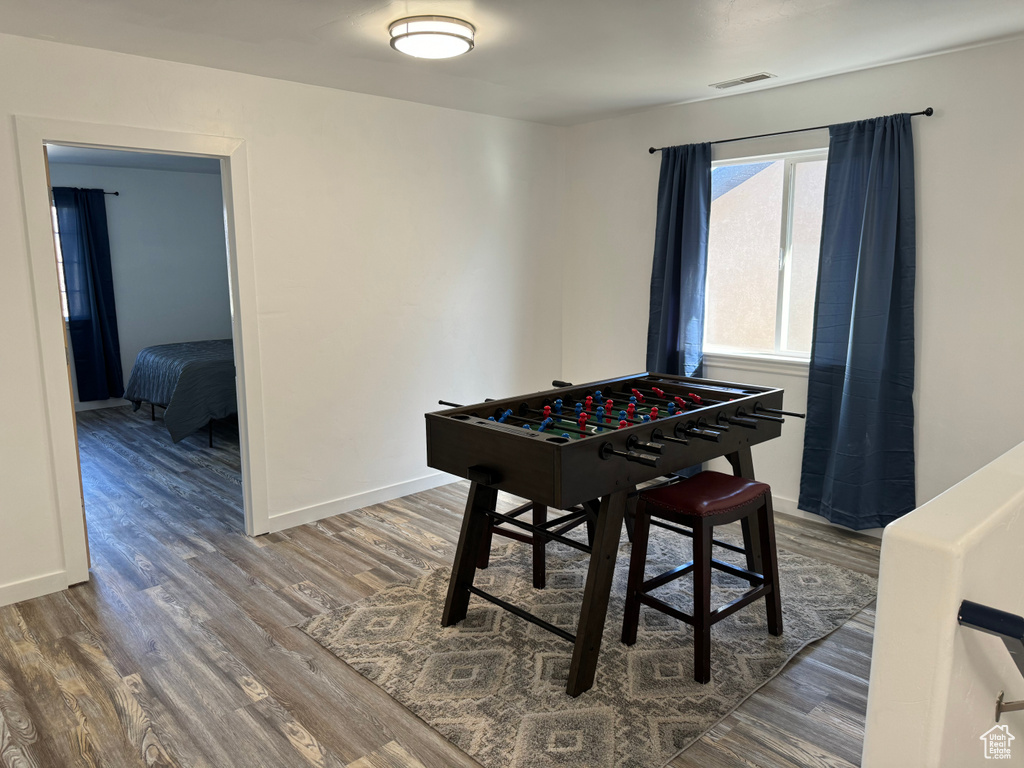 Recreation room with dark wood-type flooring