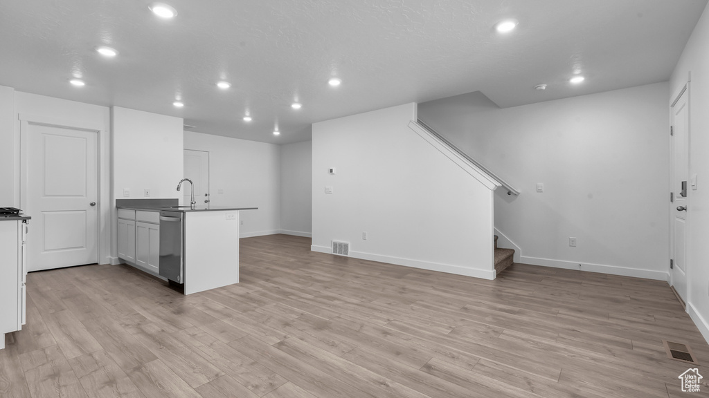 Interior space with light hardwood / wood-style floors and sink