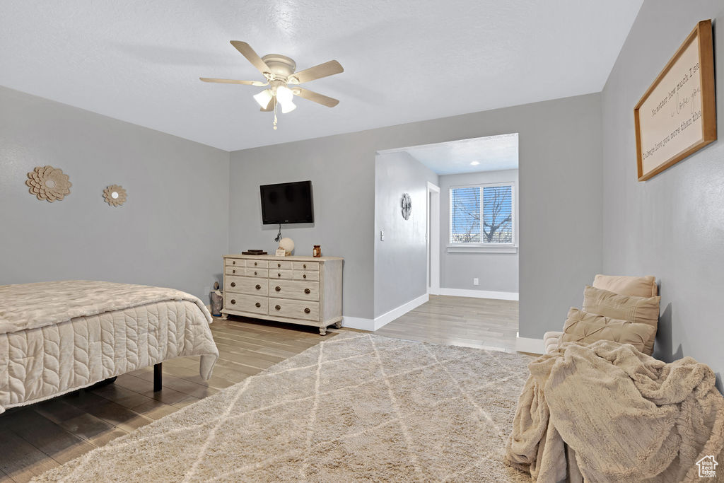 Bedroom featuring ceiling fan and wood-type flooring