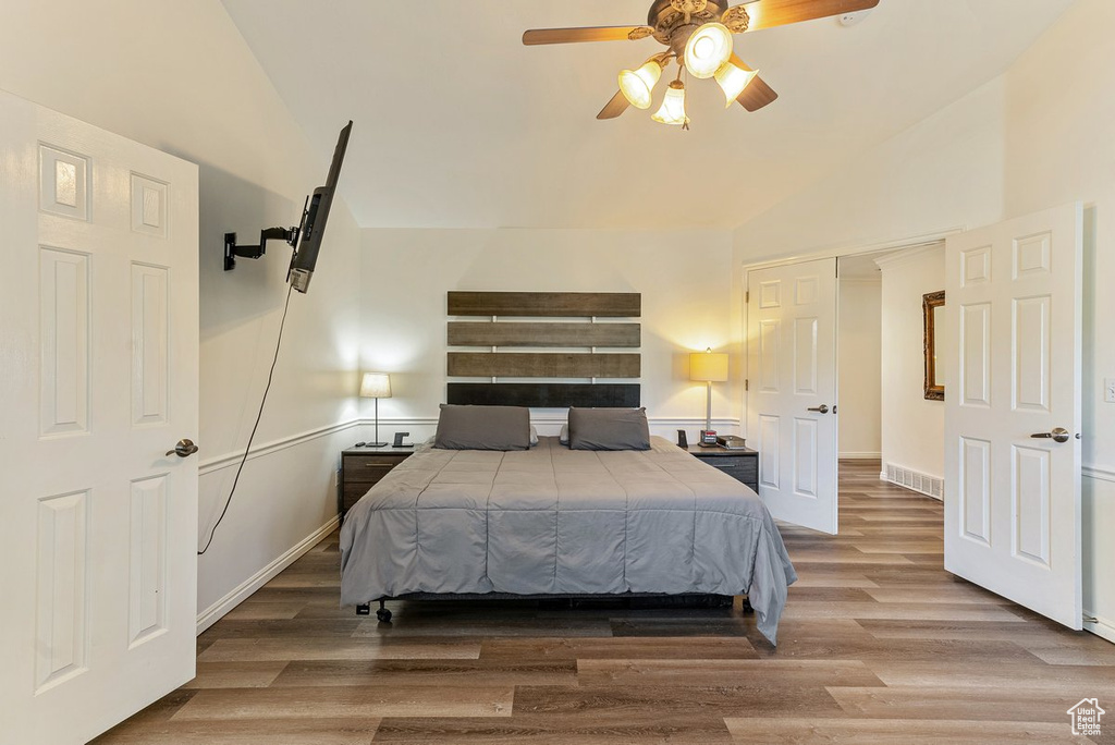 Bedroom featuring lofted ceiling, ceiling fan, and hardwood / wood-style floors