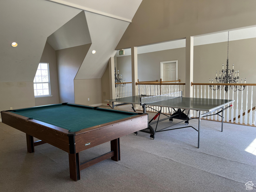 Recreation room with billiards, light colored carpet, a chandelier, and lofted ceiling