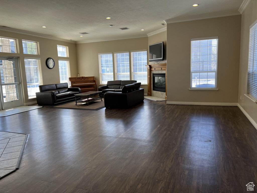 Unfurnished living room with crown molding and dark hardwood / wood-style floors