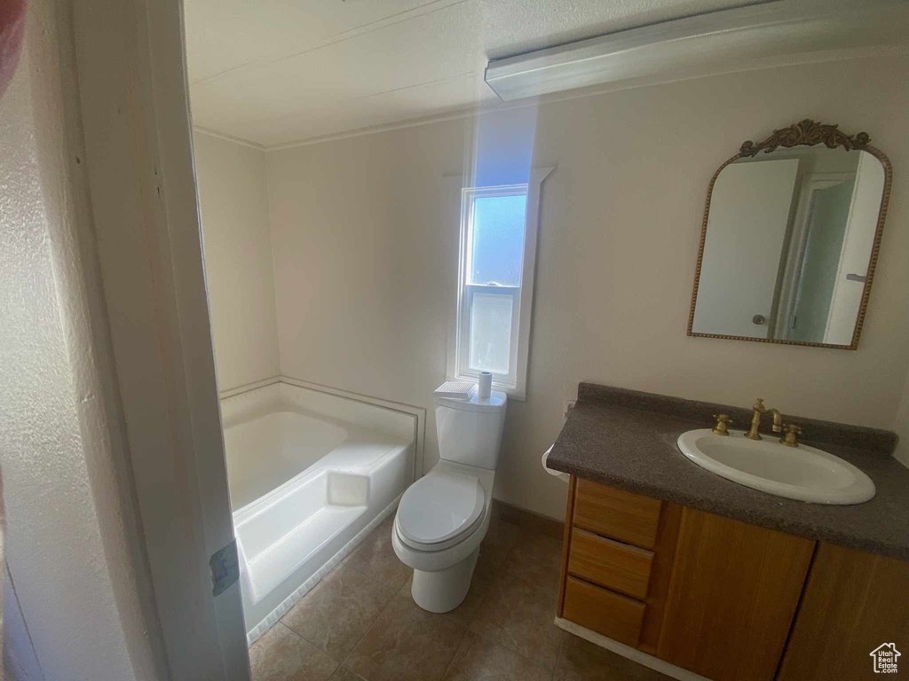 Bathroom featuring tile floors, toilet, and vanity