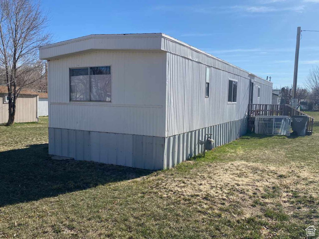 View of property exterior featuring a yard