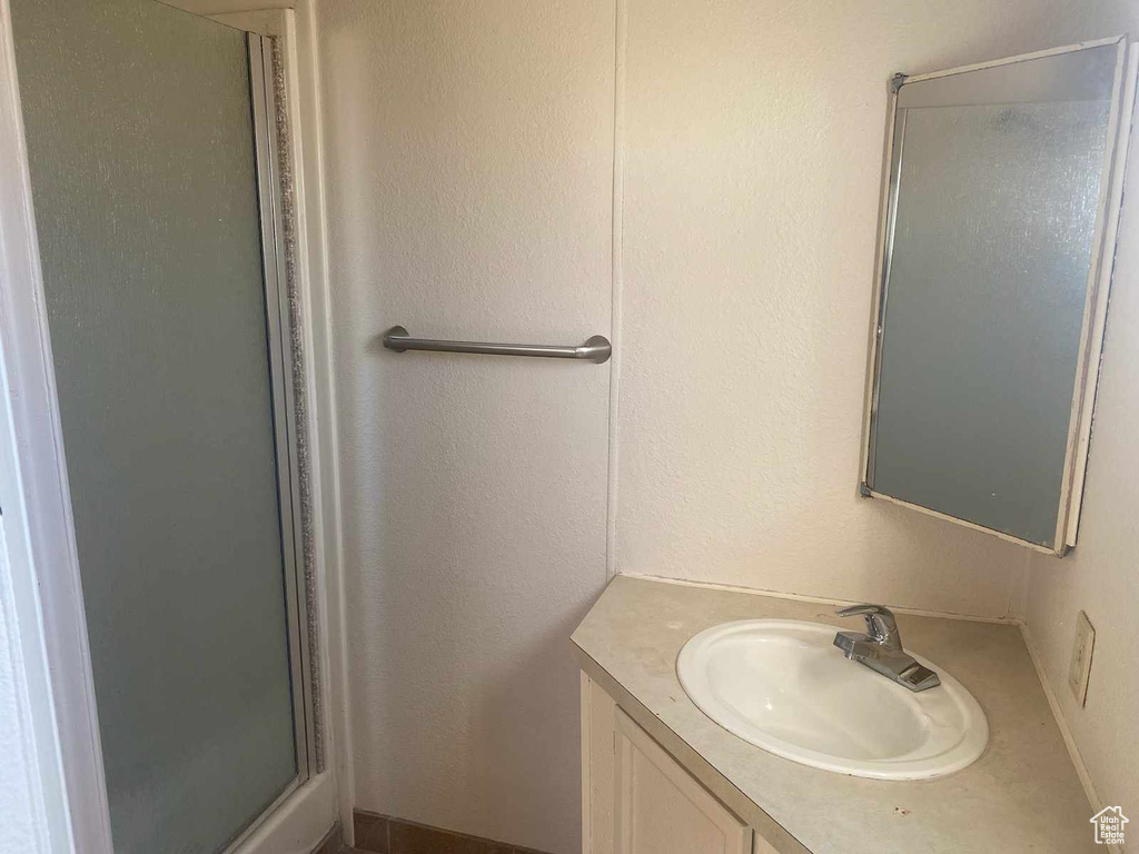 Bathroom with walk in shower and large vanity