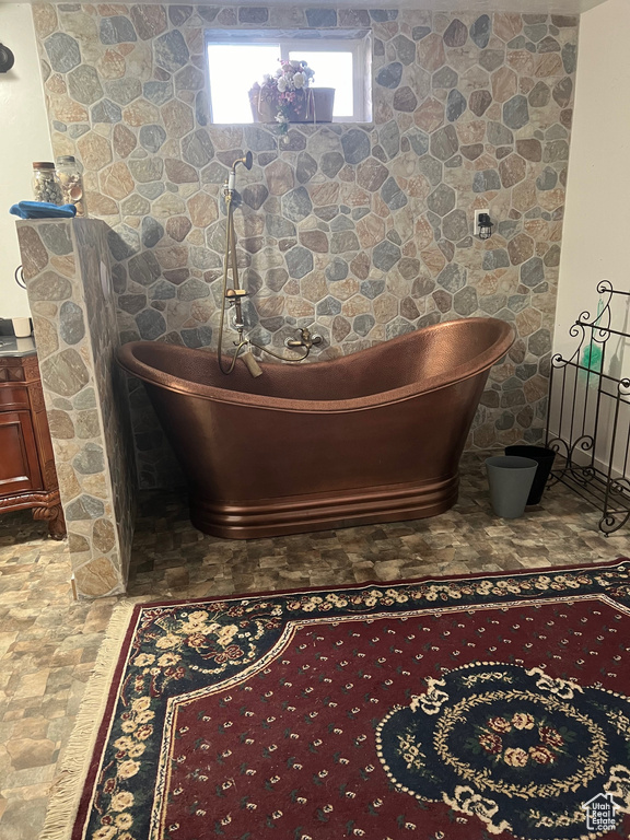 Interior details with a tub and tile flooring
