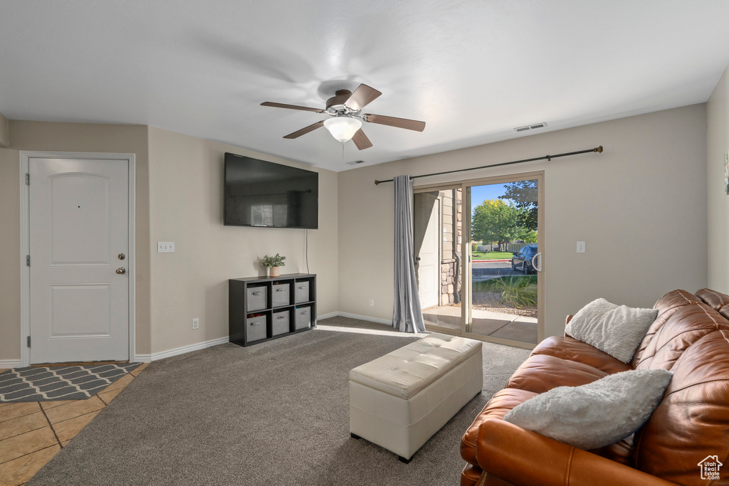Living room with dark carpet and ceiling fan