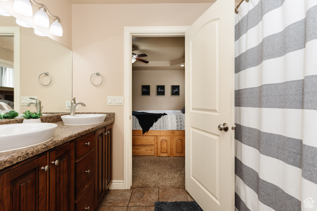 Bathroom with ceiling fan, tile flooring, and double vanity