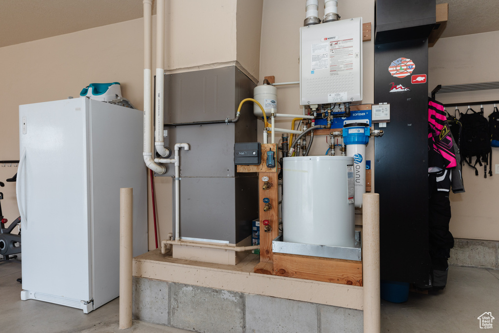 Utility room with water heater and gas water heater