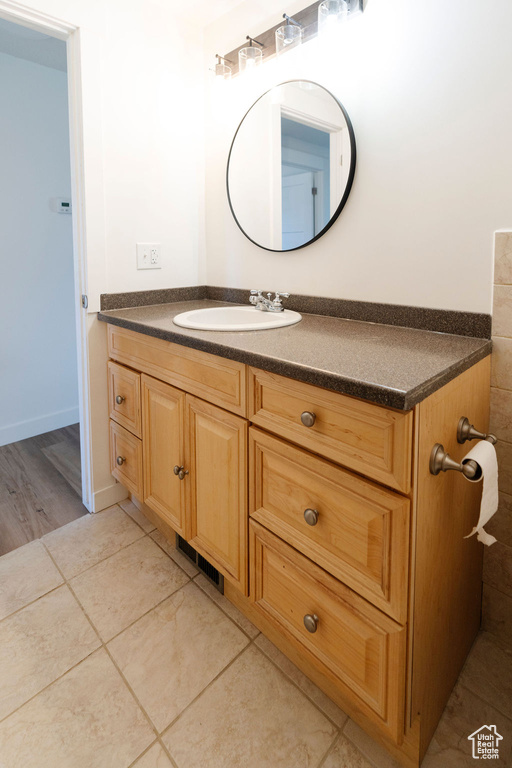 Bathroom featuring hardwood / wood-style floors and large vanity