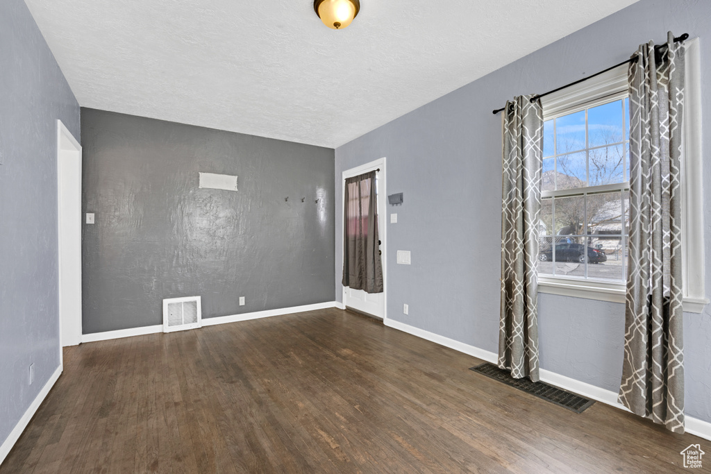 Unfurnished room with dark hardwood / wood-style floors