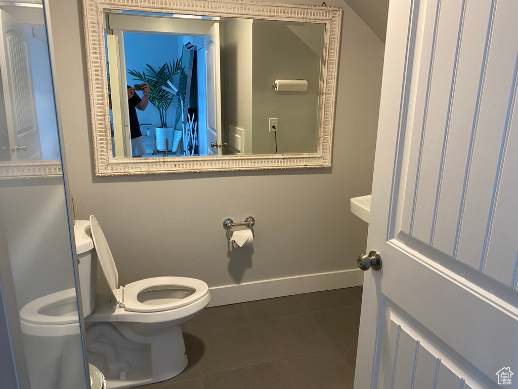 Bathroom featuring toilet and tile patterned flooring