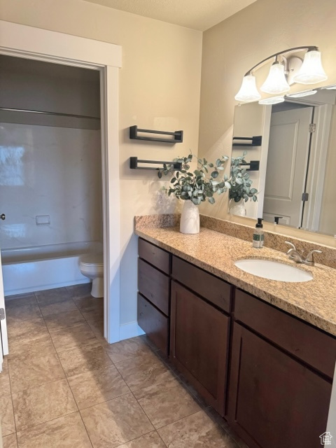 Bathroom featuring tile floors, toilet, and vanity