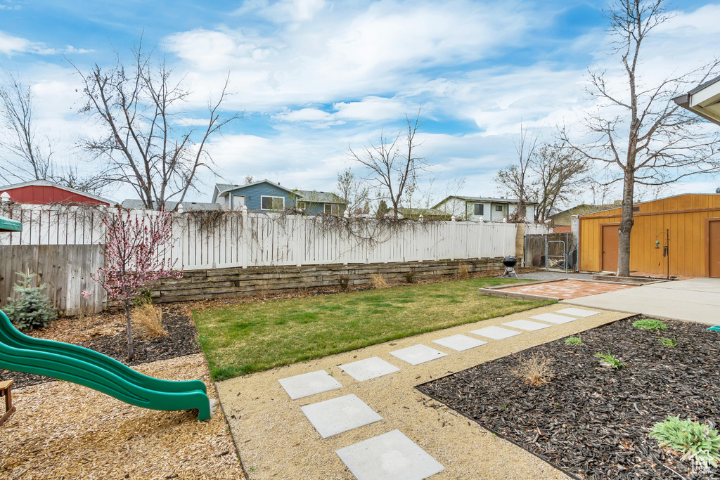 View of yard featuring a patio and a playground