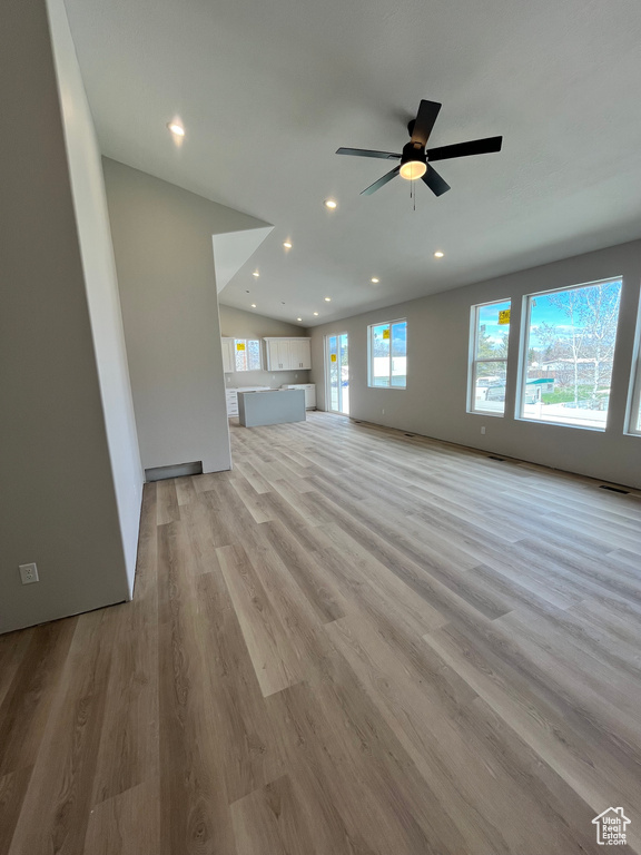 Unfurnished room with a wealth of natural light, ceiling fan, and light hardwood / wood-style floors