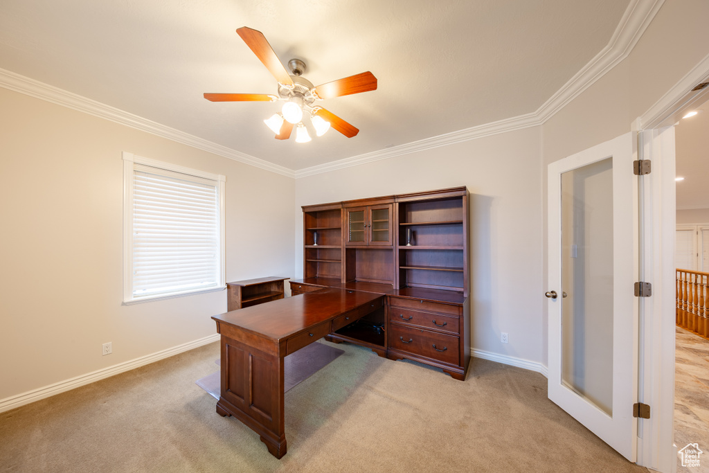 Office space with light carpet, ceiling fan, and crown molding
