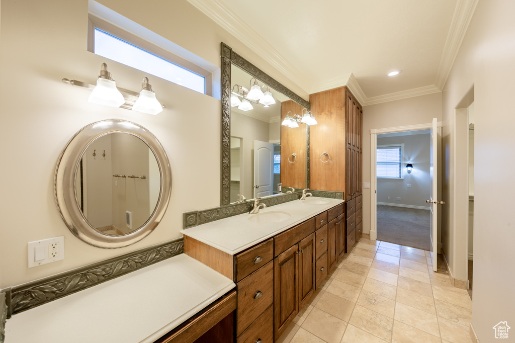 Bathroom featuring ornamental molding, tile flooring, and dual vanity