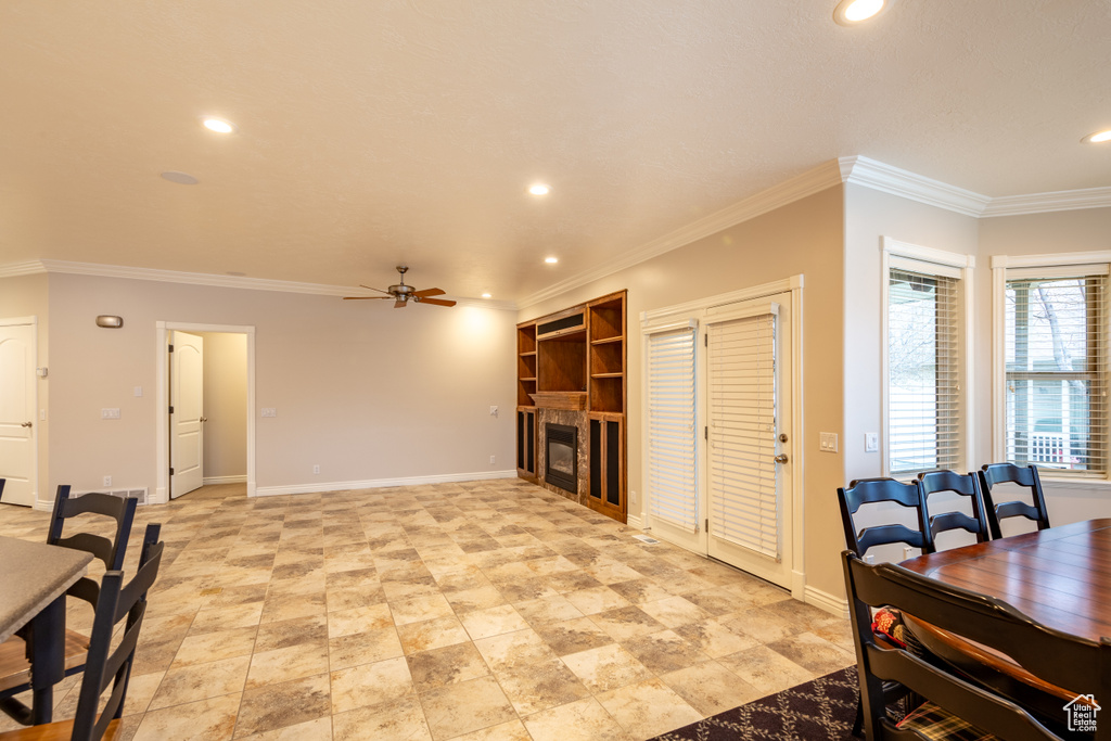 Interior space with ceiling fan and ornamental molding