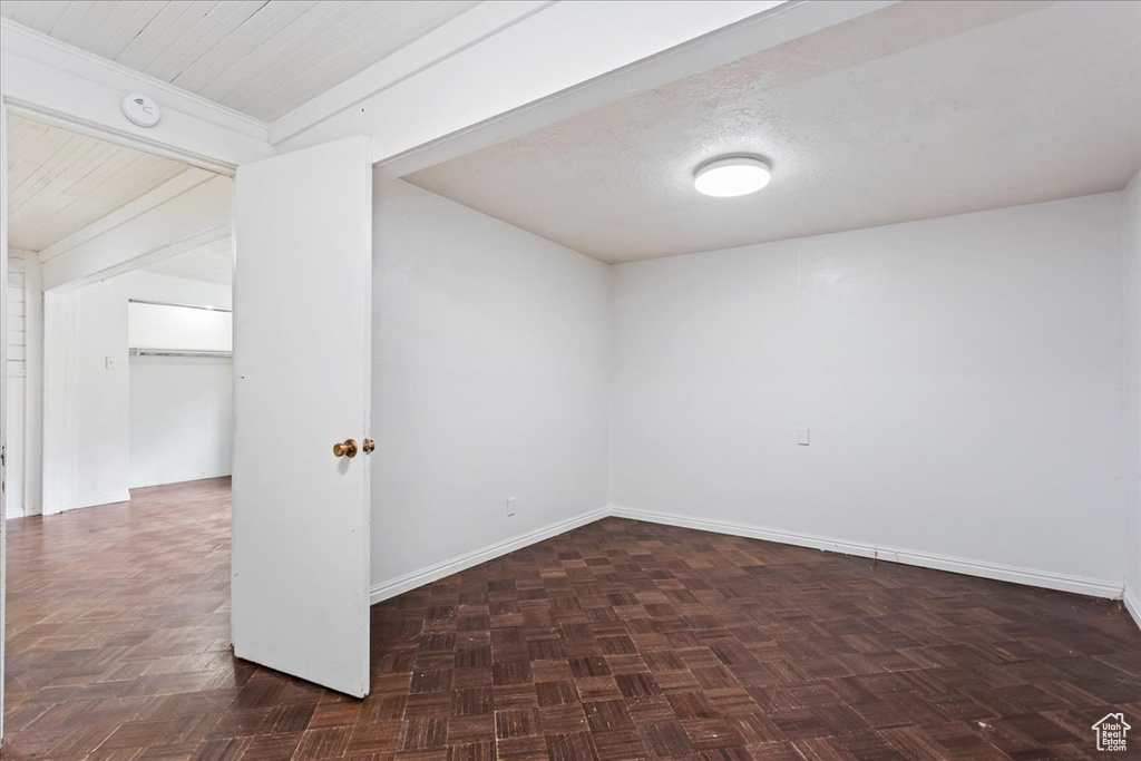 Unfurnished room with dark parquet flooring