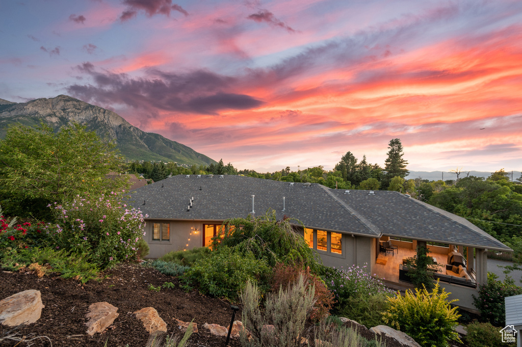 Property exterior at dusk featuring a mountain view