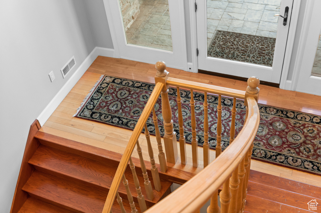 Stairway with hardwood / wood-style flooring