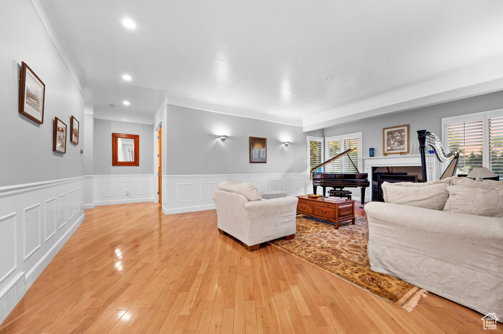 Living room featuring light hardwood / wood-style flooring and ornamental molding