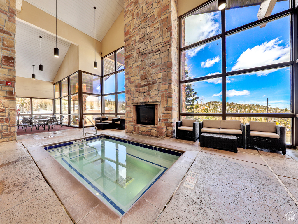View of swimming pool featuring a stone fireplace