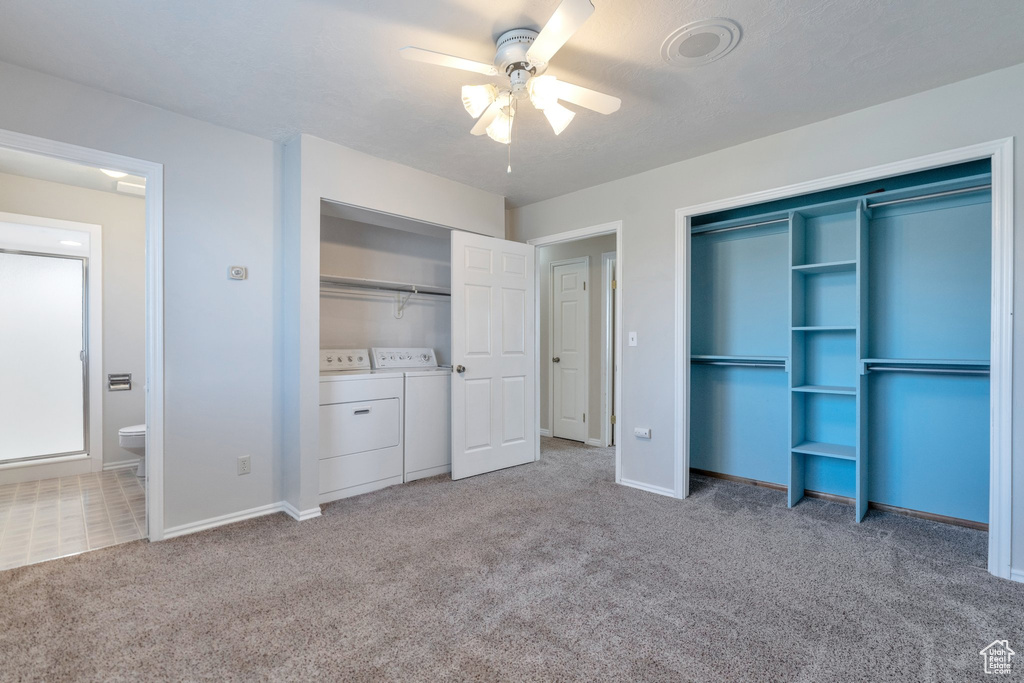 Unfurnished bedroom featuring ensuite bathroom, ceiling fan, independent washer and dryer, and light colored carpet