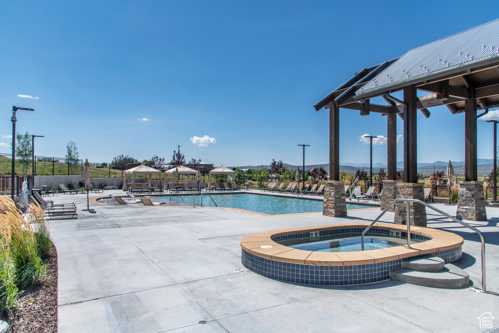 View of pool featuring a patio and a community hot tub