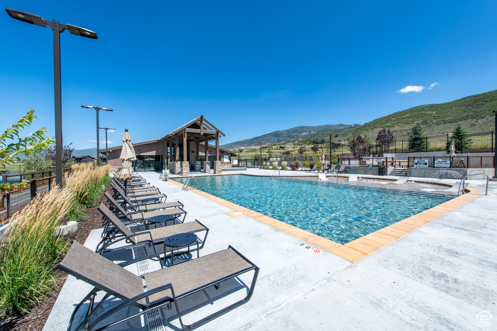 View of swimming pool featuring a mountain view and a patio area
