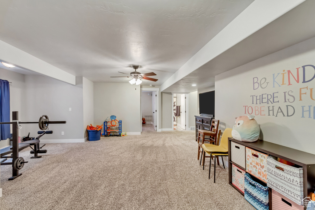 Recreation room featuring light carpet and ceiling fan