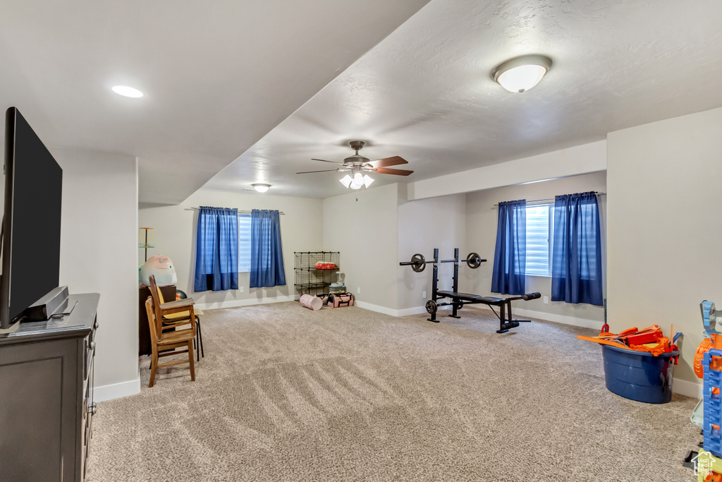 Playroom featuring ceiling fan and light carpet