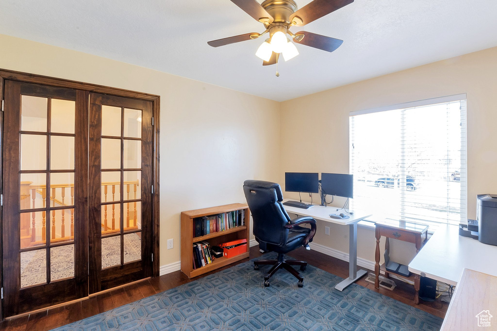 Office space with ceiling fan and dark wood-type flooring