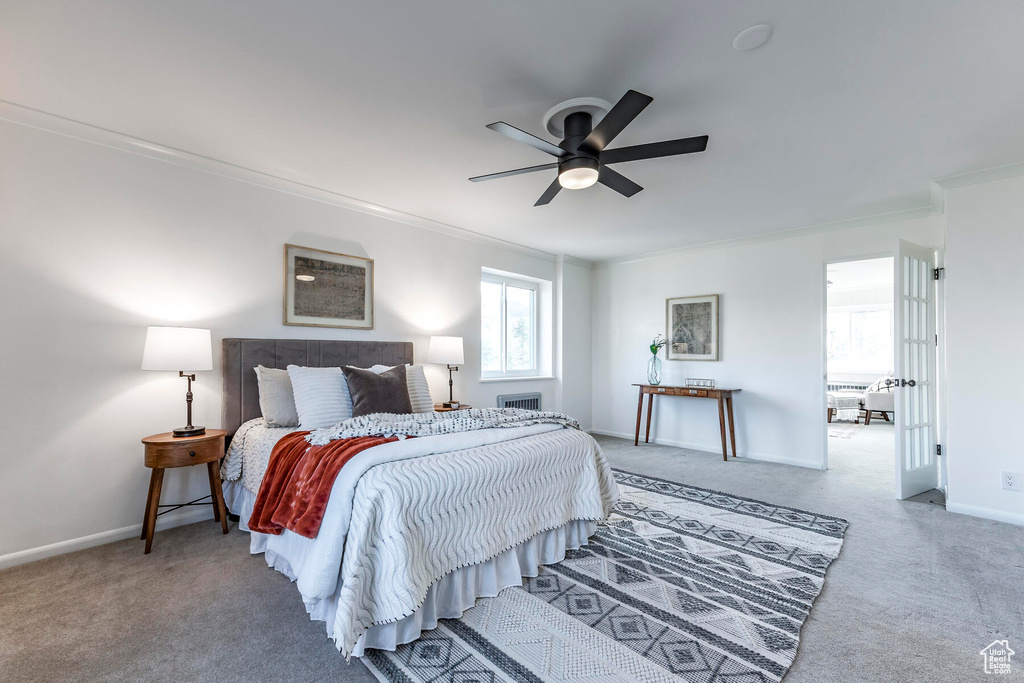 Bedroom featuring ornamental molding, ceiling fan, and carpet floors