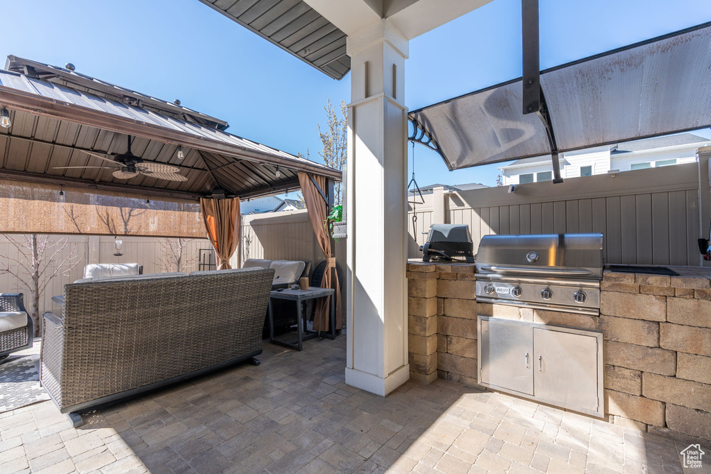 View of patio / terrace featuring area for grilling, ceiling fan, a gazebo, and grilling area