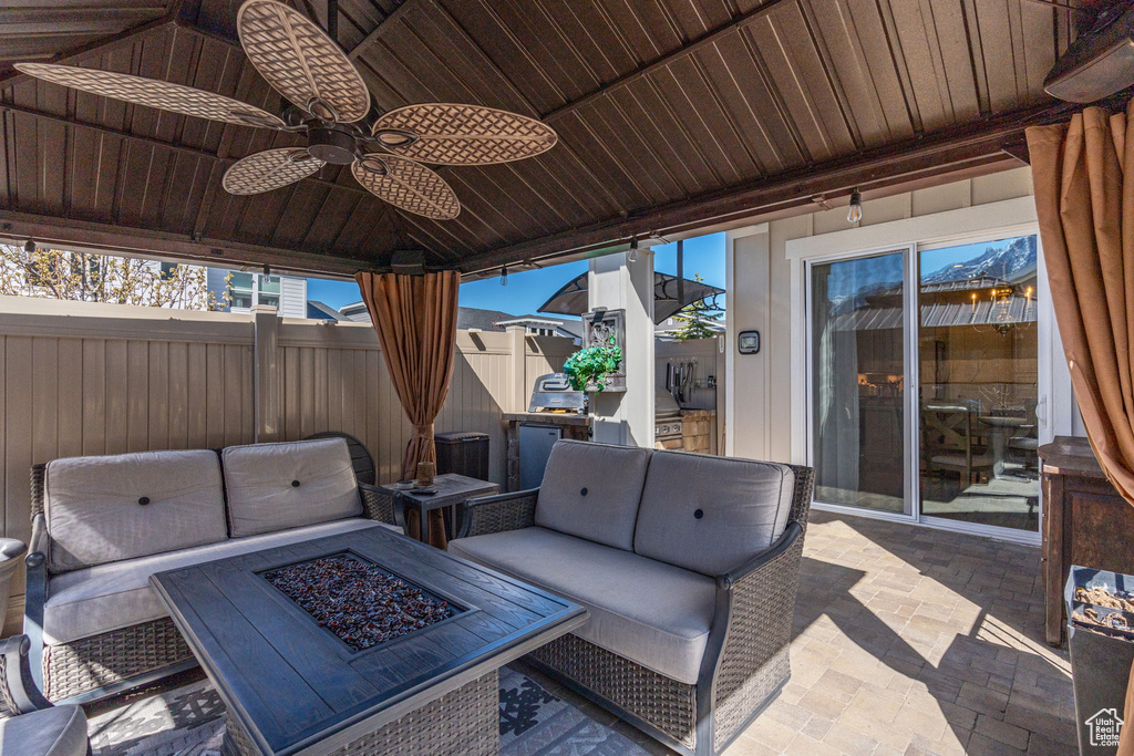 View of patio / terrace with an outdoor fire pit and ceiling fan