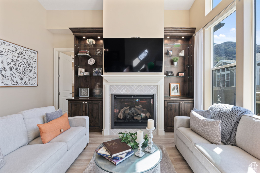 Living room featuring light hardwood / wood-style flooring and a tile fireplace