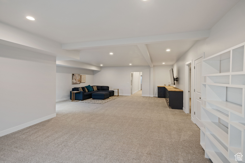 Carpeted living room with beamed ceiling