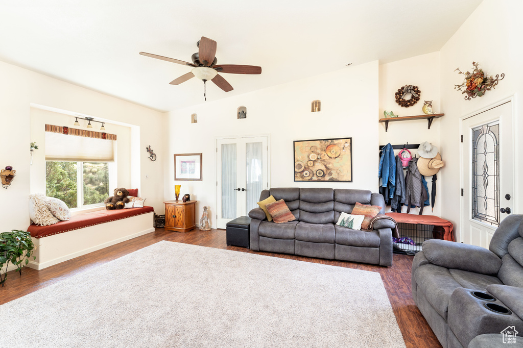 Living room featuring ceiling fan and dark hardwood / wood-style flooring