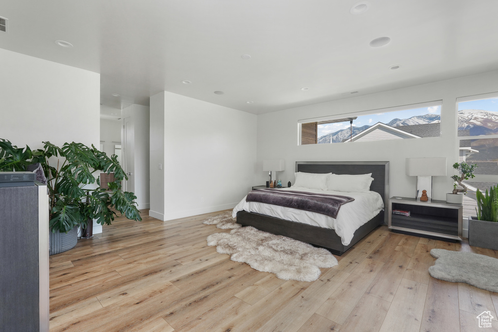 Bedroom featuring light hardwood / wood-style flooring and multiple windows