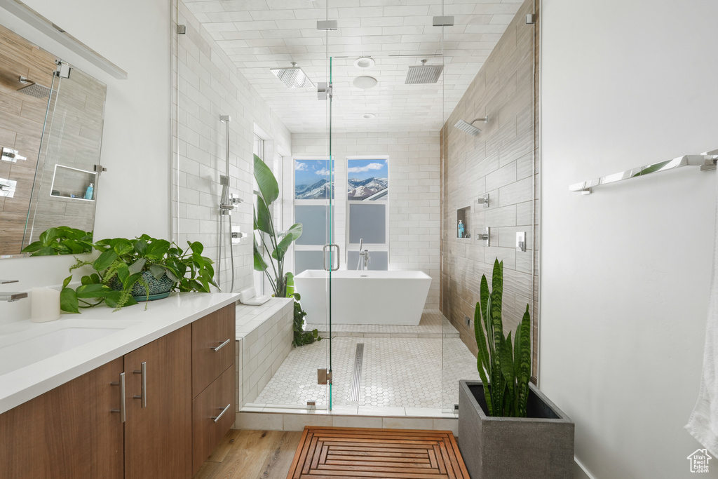Bathroom with hardwood / wood-style flooring, vanity, and an enclosed shower