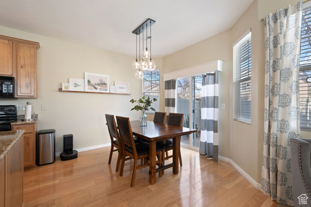 Dining area featuring light hardwood / wood-style flooring and a notable chandelier
