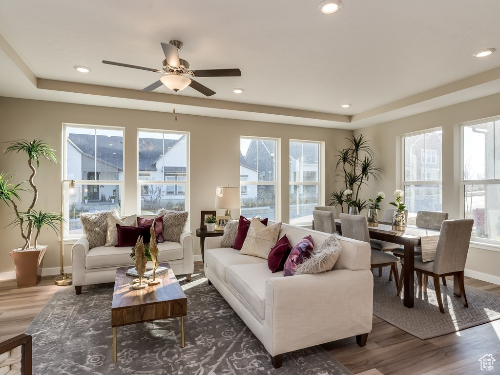 Living room featuring ceiling fan, hardwood / wood-style floors, and plenty of natural light