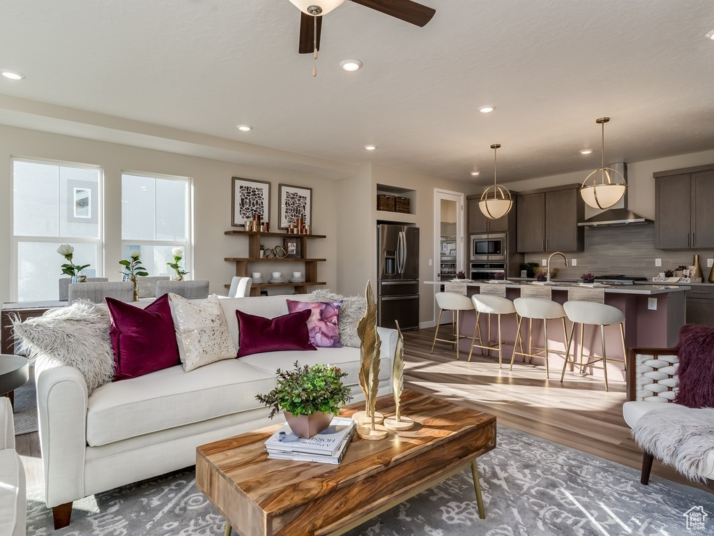 Living room featuring sink, dark hardwood / wood-style flooring, and ceiling fan