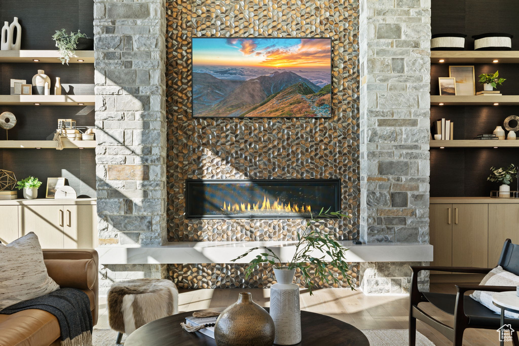 Living room featuring tile flooring and a stone fireplace
