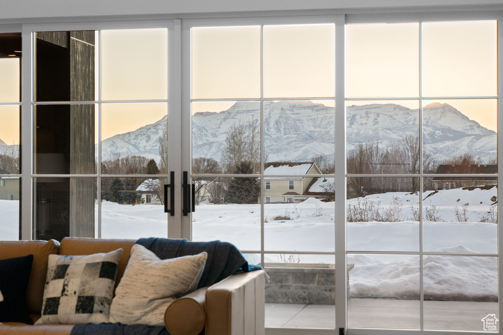 Bedroom with french doors, a mountain view, and multiple windows
