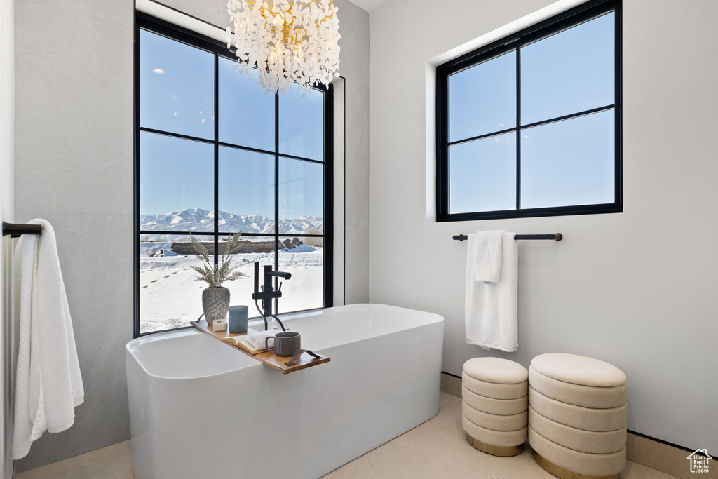 Bathroom with a mountain view, a chandelier, and plenty of natural light