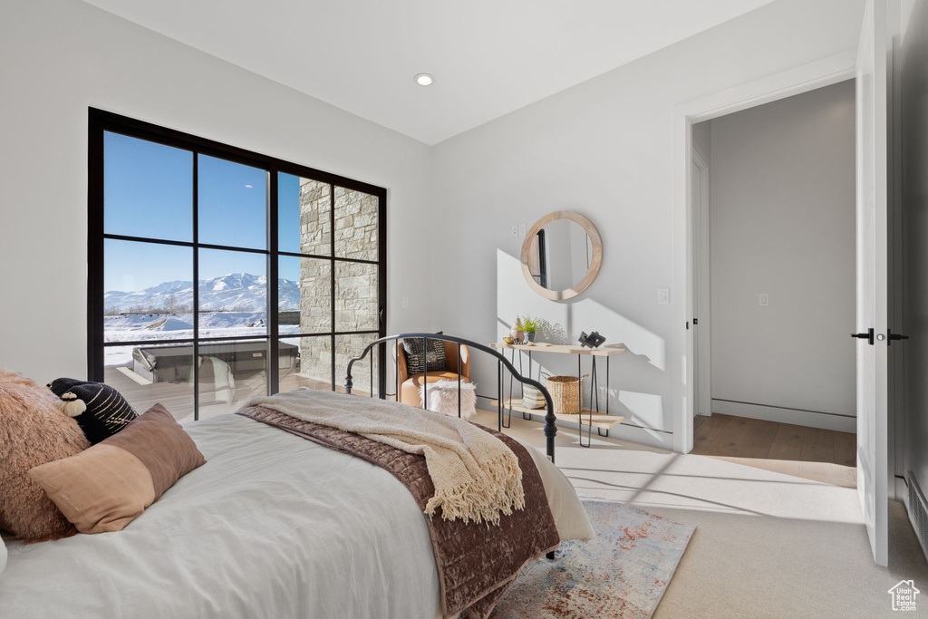 Bedroom featuring light hardwood / wood-style flooring and a mountain view